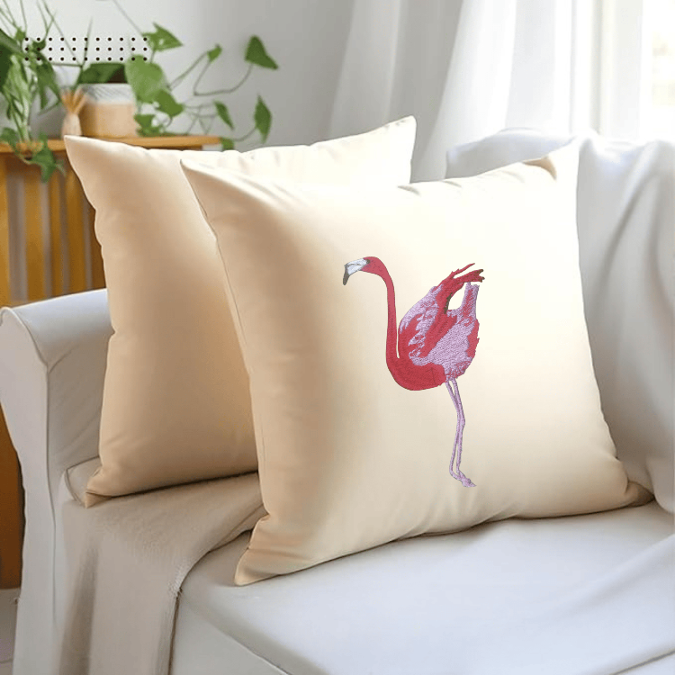 Beige pillow with a flamingo design on a white couch