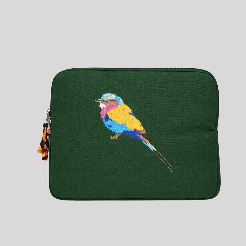 Green laptop sleeve with embroidered colourful bird design on a light grey background