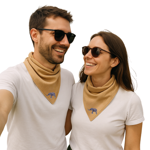 Two people wearing matching beige scarves with elephant embroidery on white shirts, standing close together.