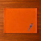  Burnt Orange  with a bird embroidery  on a wooden surface