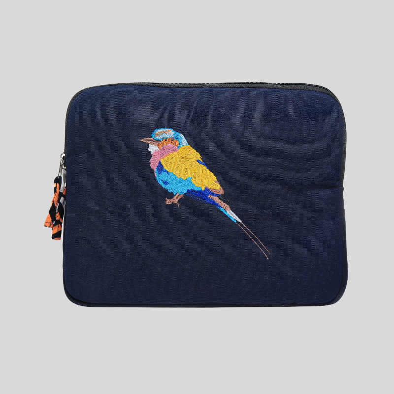 Navy blue laptop sleeve with embroidered colourful bird design on a light grey background