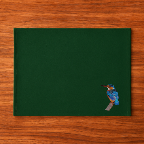 Pine Green Tablemat with a bird embroidery on a wooden surface
