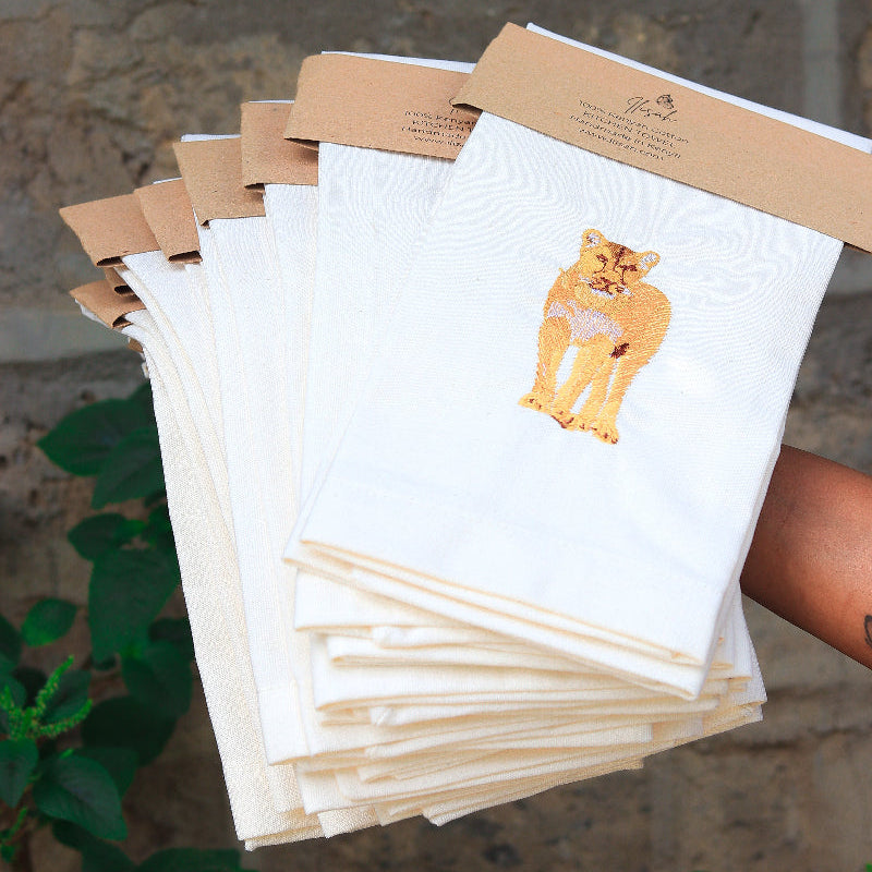 Stack of tea towels with a lion embroidery  background