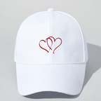 White cap with red heart design on a light gray background
