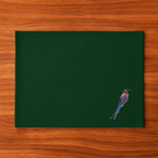 Green Tablemat with a bird illustration on a wooden surface