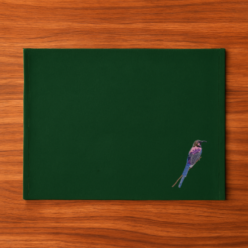 Green Tablemat with a bird illustration on a wooden surface