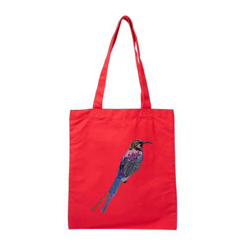 Red tote bag with a bird embroidery on a white background