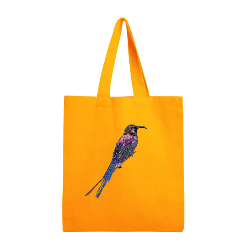 Mustard tote bag with a bird embroidery on a white background