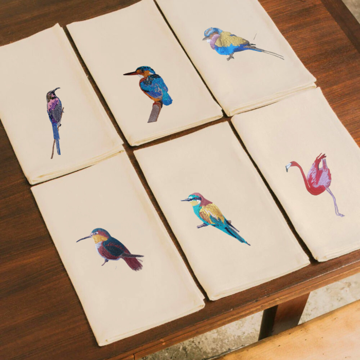 Set of Napkins  with bird  embroidery on a wooden surface