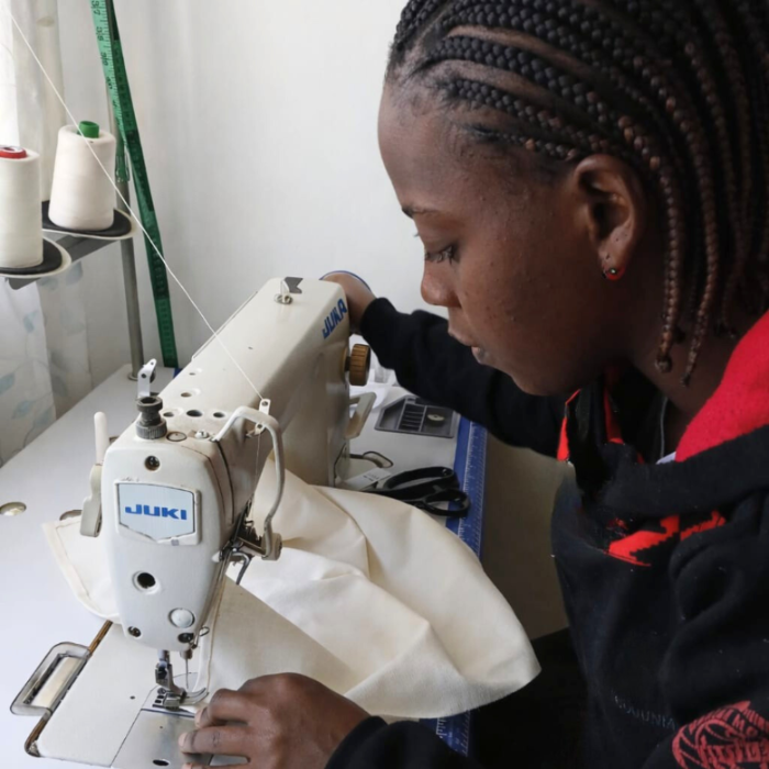 Tailor  using sewing machine in the workshop.