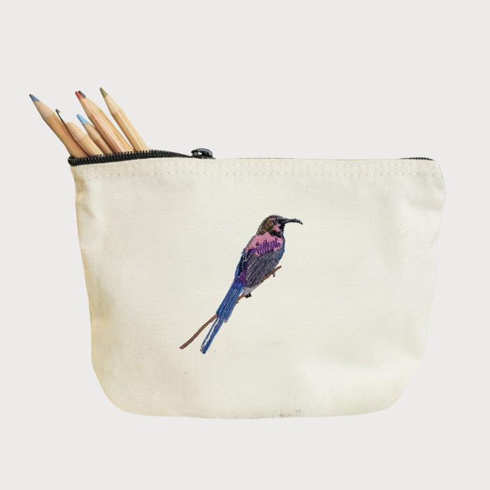 Canvas pouch with bird Embroidery and pencils on a white background