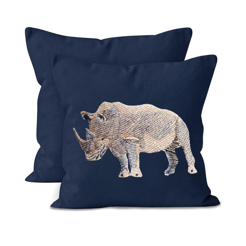 Navy blue pillow with embroidered rhino design on a white background