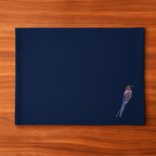 Navy blue Tablemat with a embroidered bird  on a wooden surface