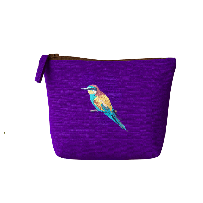 Purple pouch with a bird embroidery  on a white background