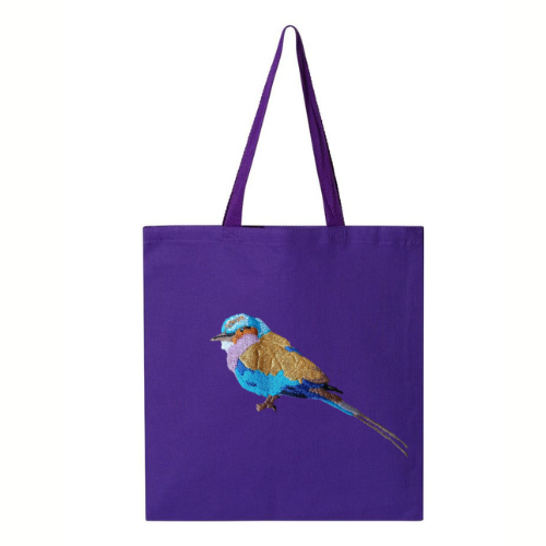 Purple tote bag with a  bird embroidery on a white background