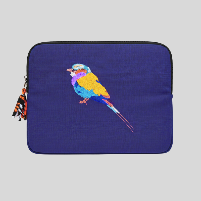 Purple laptop sleeve with a colourful bird design on a grey background