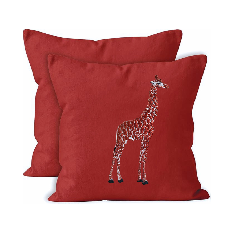 Red pillow with a giraffe design on a white background
