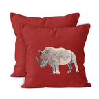 Red pillows with embroidered rhino design on a white background