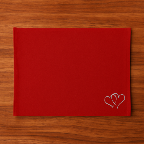 Red Tablemat  with a heart embroidery on a wooden surface