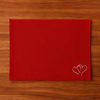 Red Tablemat  with a heart embroidery on a wooden surface