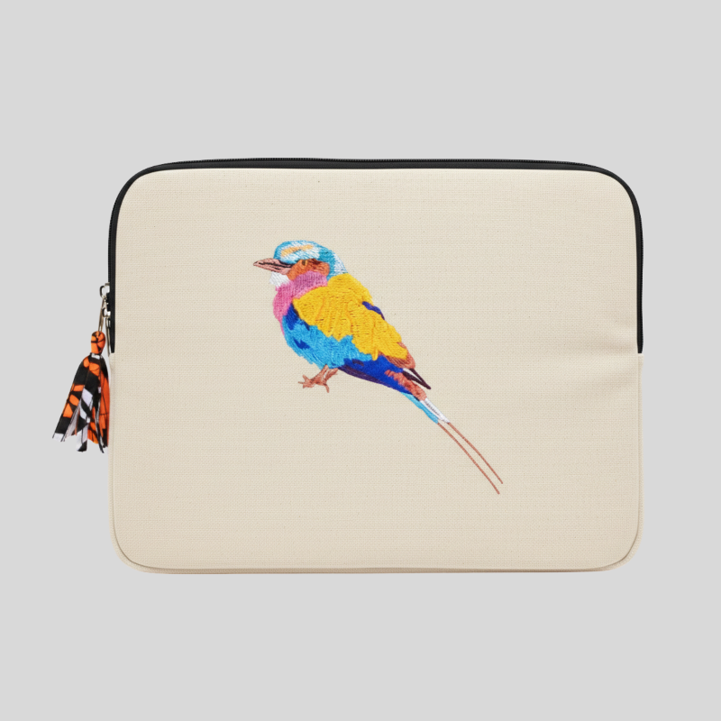 Laptop sleeve with a colorful bird design on a beige background