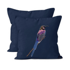 Navy blue pillow with embroidered bird design on a white background