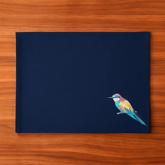 Handmade Ilisah Bee Eater Embroidery table mats in navy blue, set of 4, made from 100% cotton canvas for stylish dining.