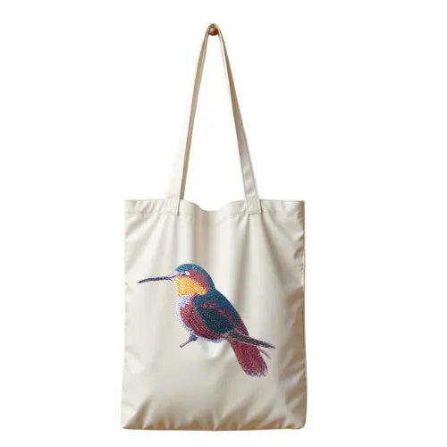ILISAH Canvas Tote featuring a vibrant hummingbird design, available in black, burnt orange, and navy blue, perfect for ev...