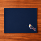 Navy blue cloth placemat with a hummingbird embroidery design