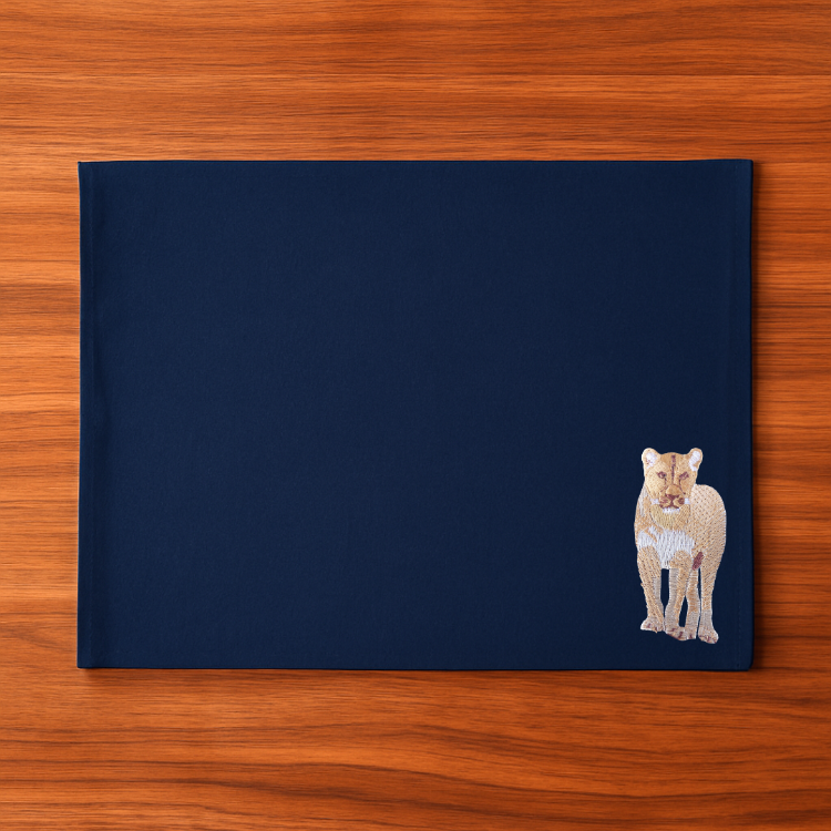 Navy blue placemat with a lion embroidery design 