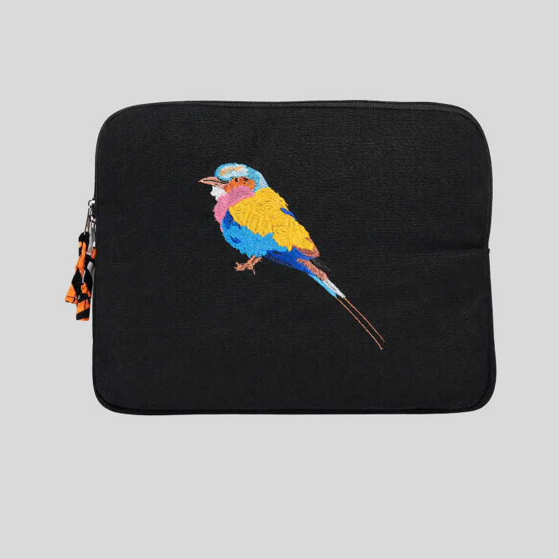 Black laptop sleeve with a colourful embroidered bird design on a gray background