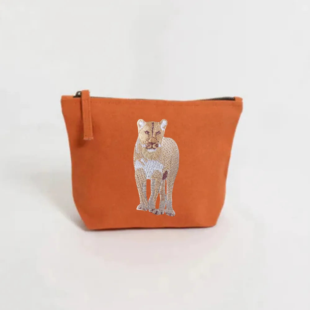 Handmade ILISAH Lion Make Up Pouch in Burnt Orange, a compact canvas bag for organizing makeup and essentials.