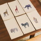 Handmade Ilisah cotton napkins with elephant embroidery, available in beige white or brown khaki, perfect for dining and s...