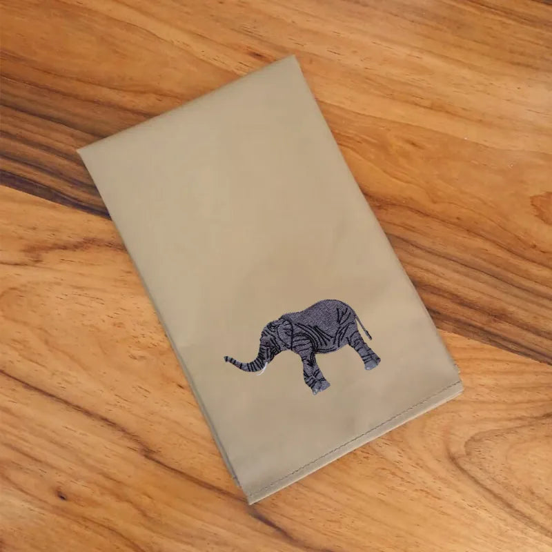 Handmade Ilisah cotton napkins with elephant embroidery, available in beige white or brown khaki, perfect for dining and s...