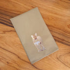 Handmade cotton napkins with lion embroidery by Ilisah, available in brown khaki and beige white, perfect for dining tables.