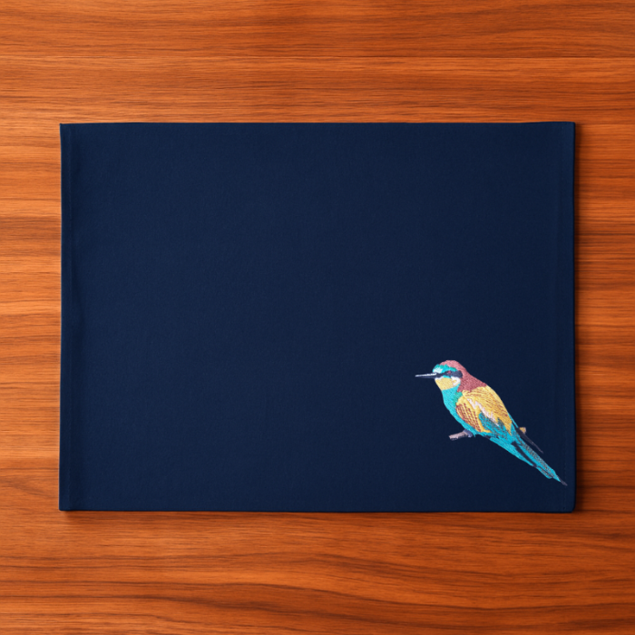 Navy blue cotton canvas table mats with a colorful bird embroidery