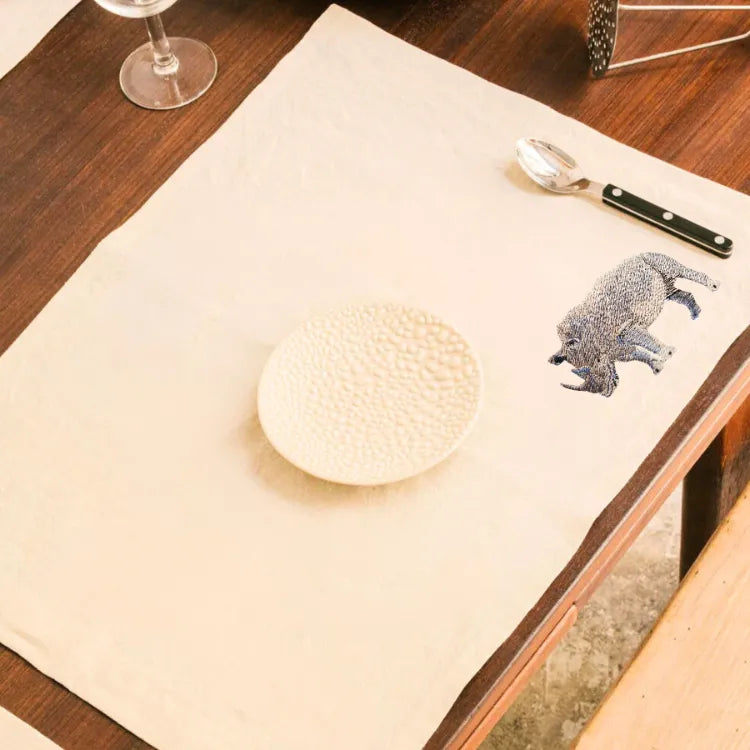 Handmade Rhino Embroidery table mats by Ilisah, set of 4 in white, durable cotton canvas, perfect for dining decor.