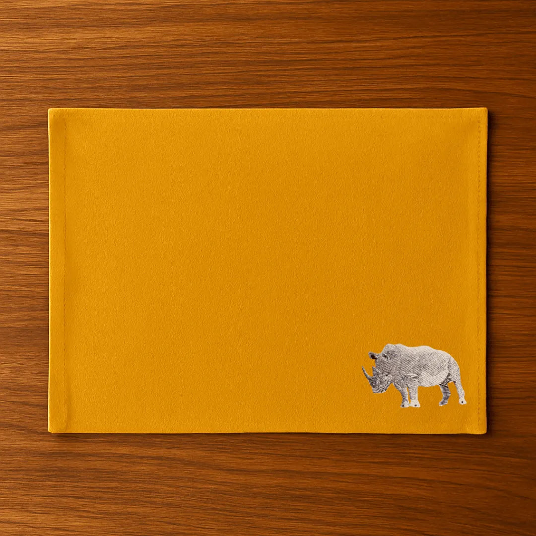 Handmade Rhino Embroidery table mats by Ilisah, set of 4 in white, durable cotton canvas, perfect for dining decor.