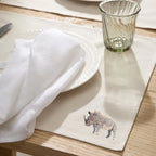 Handmade Rhino Embroidery table mats by Ilisah, set of 4 in white, durable cotton canvas, perfect for dining decor.