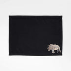 Handmade Rhino Embroidery table mats by Ilisah, set of 4 in white, durable cotton canvas, perfect for dining decor.