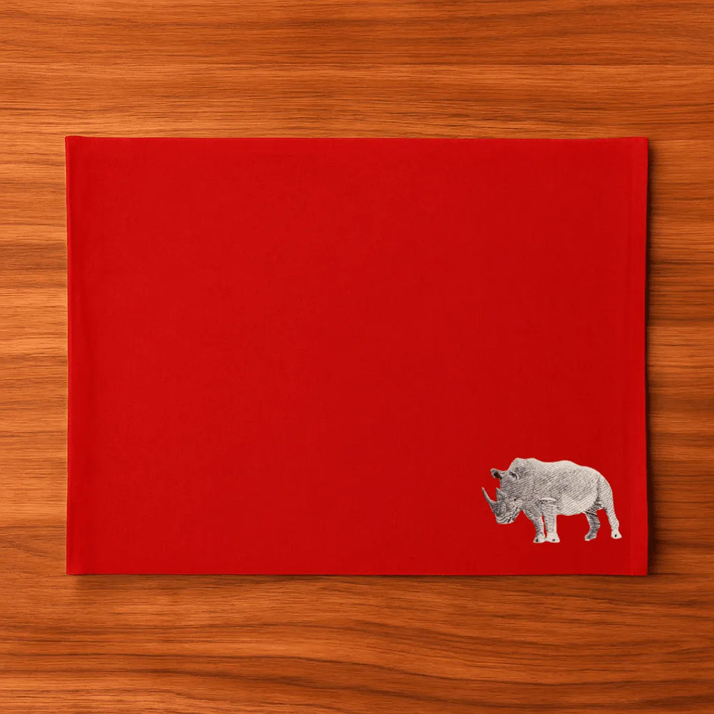 Handmade Rhino Embroidery table mats by Ilisah, set of 4 in white, durable cotton canvas, perfect for dining decor.