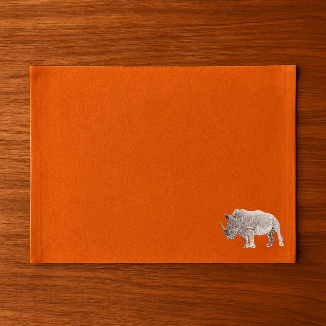 Handmade Rhino Embroidery table mats by Ilisah, set of 4 in white, durable cotton canvas, perfect for dining decor.