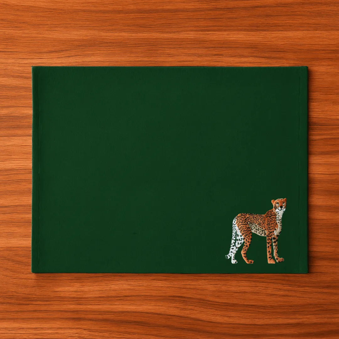 Handmade Ilisah Cheetah Embroidery table mats in Pine Green, set of 4, 100% cotton canvas, perfect for dining decor.
