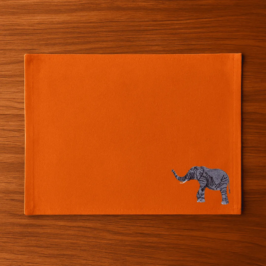 Handmade Ilisah table mats featuring elephant embroidery, available in burnt orange, beige white, or navy blue, set of 4.