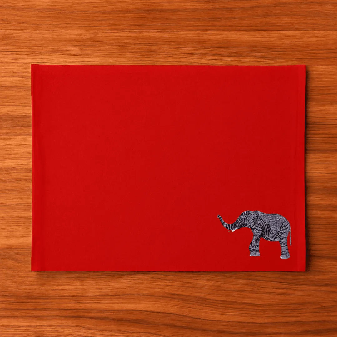 Handmade Ilisah table mats featuring elephant embroidery, available in burnt orange, beige white, or navy blue, set of 4.