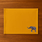 Handmade Ilisah table mats featuring elephant embroidery, available in burnt orange, beige white, or navy blue, set of 4.