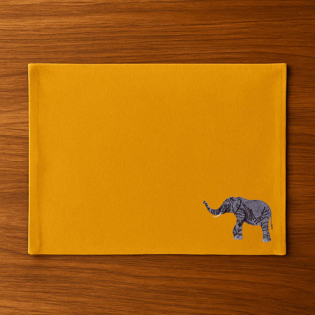 Handmade Ilisah table mats featuring elephant embroidery, available in burnt orange, beige white, or navy blue, set of 4.