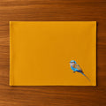 Handmade Ilisah table mats featuring lilac-breasted roller embroidery, set of 4 in mustard, perfect for dining and table d...