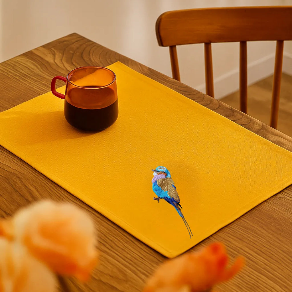 Handmade Ilisah table mats featuring lilac-breasted roller embroidery, set of 4 in mustard, perfect for dining and table d...