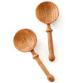 Handcrafted wooden spice spoons by ILISAH, set of six, featuring intricate animal carvings, perfect for kitchen gifting.